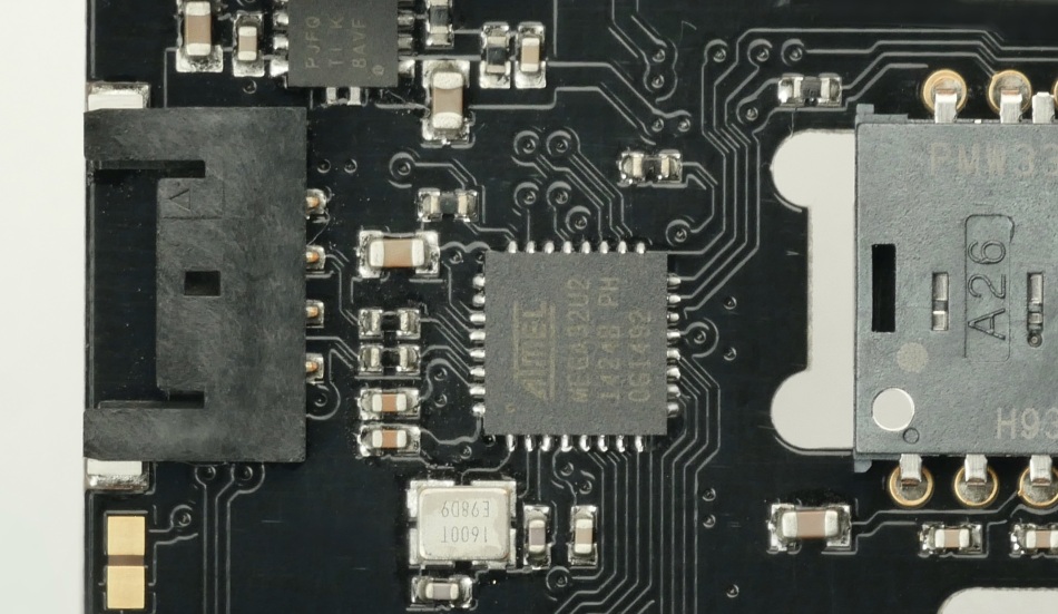 This picture shows the MCU of the Zaunkoenig M1K PCB, the Microchip ATmega32U2, surrounded by traces and vias.